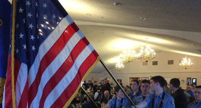 Officers hold flags during an event